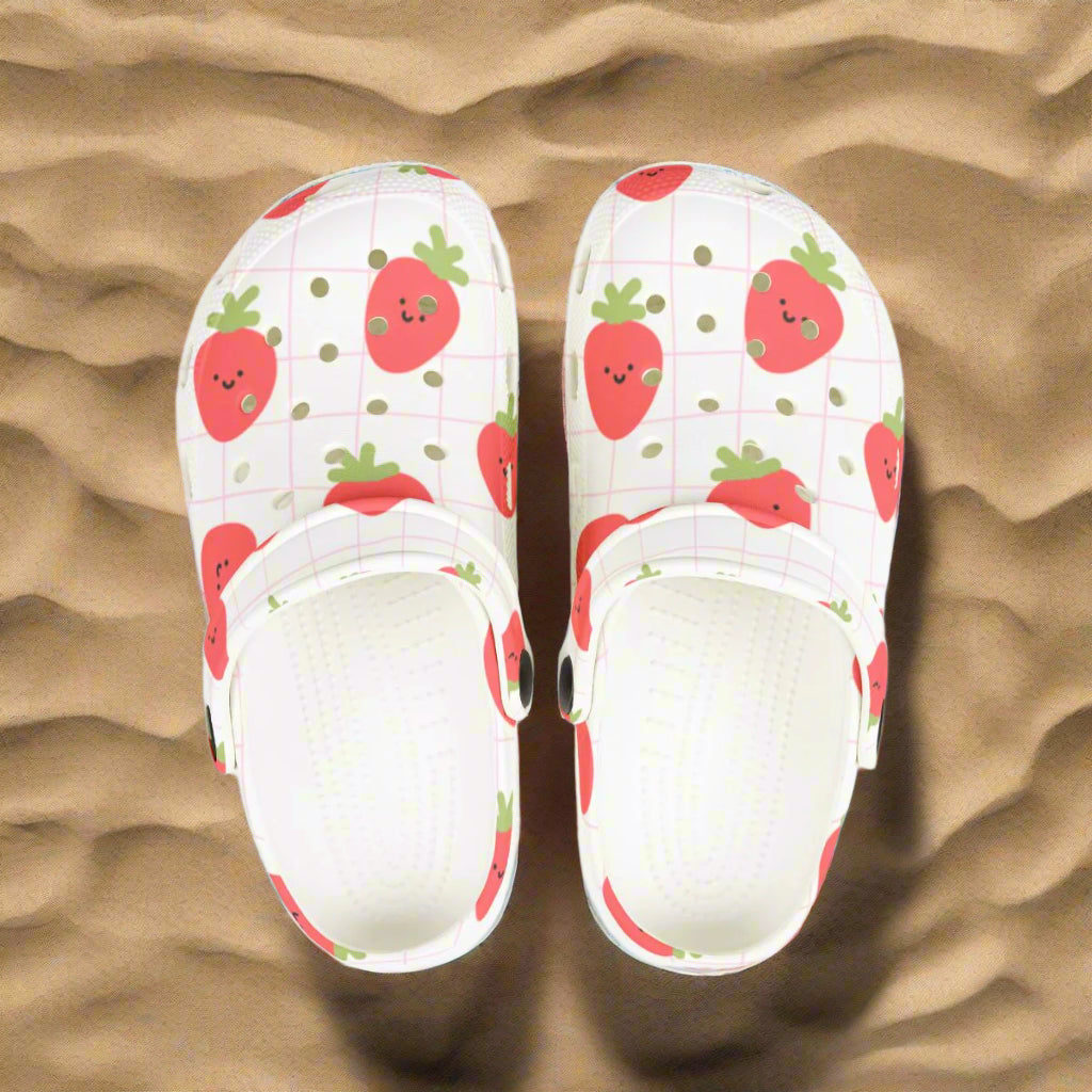 White slippers with strawberry pattern on a white background