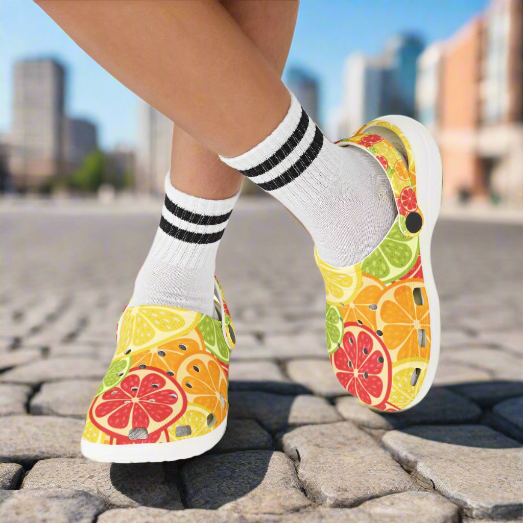 Colorful fruit-patterned shoes worn with white socks on a white background