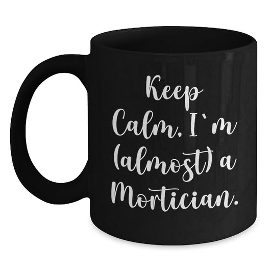Funny Mortician Gifts, Keep Calm I'm (almost) A Mortician Black Coffee Mug for Christmas, Gifts from Men to Mortician Friends - Main