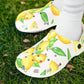 White clogs with lemon design worn by a person with white socks on a white background
