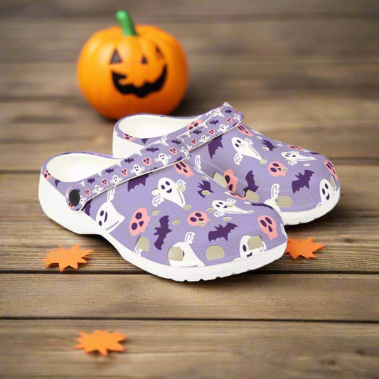 Pair of purple clogs with Halloween-themed design on a white background