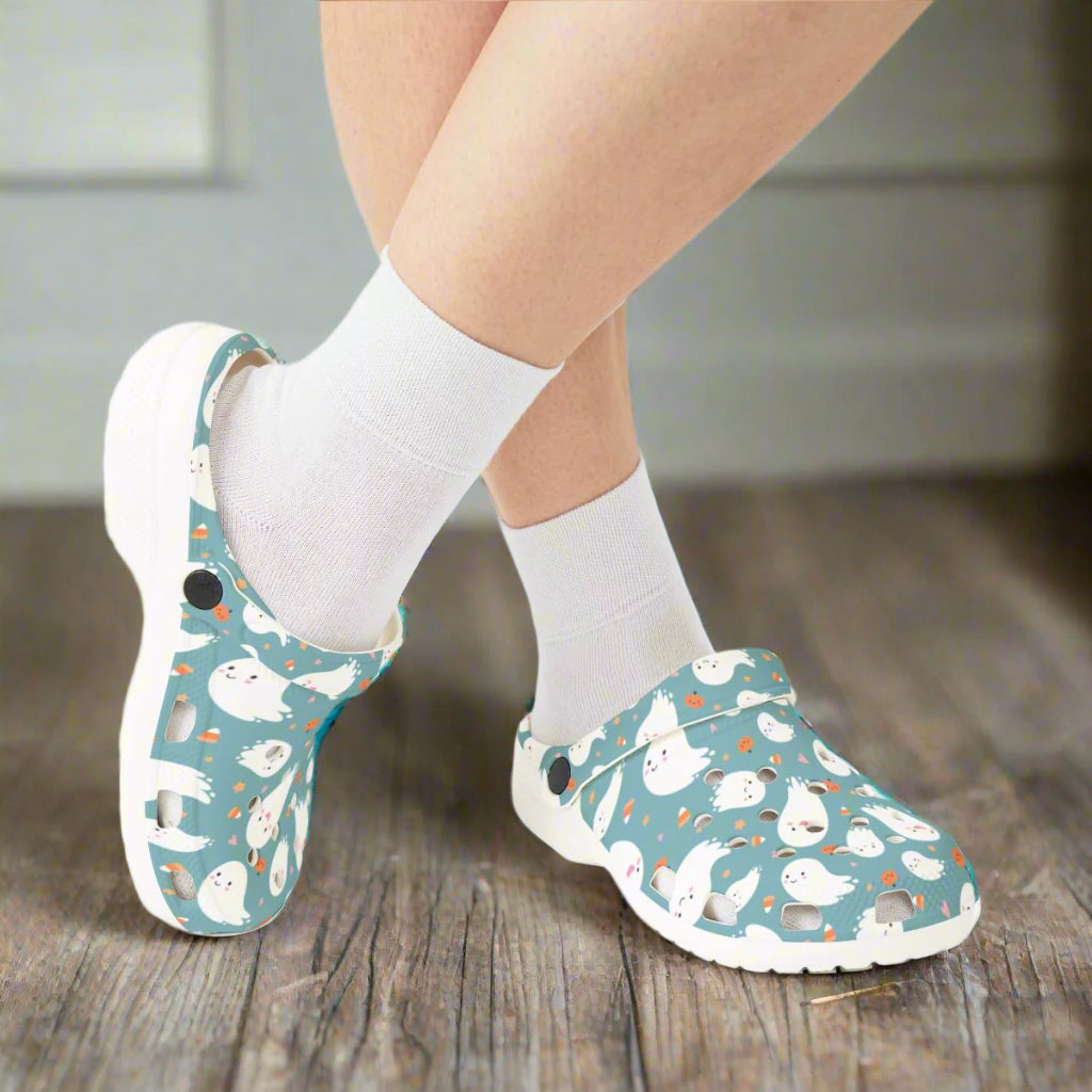 Clogs with a cartoon character pattern worn with white socks on a white background