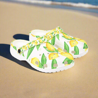 White clogs with lemon and leaf pattern on a white background