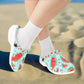 Children's shoes with watermelon pattern worn with white socks on a white background