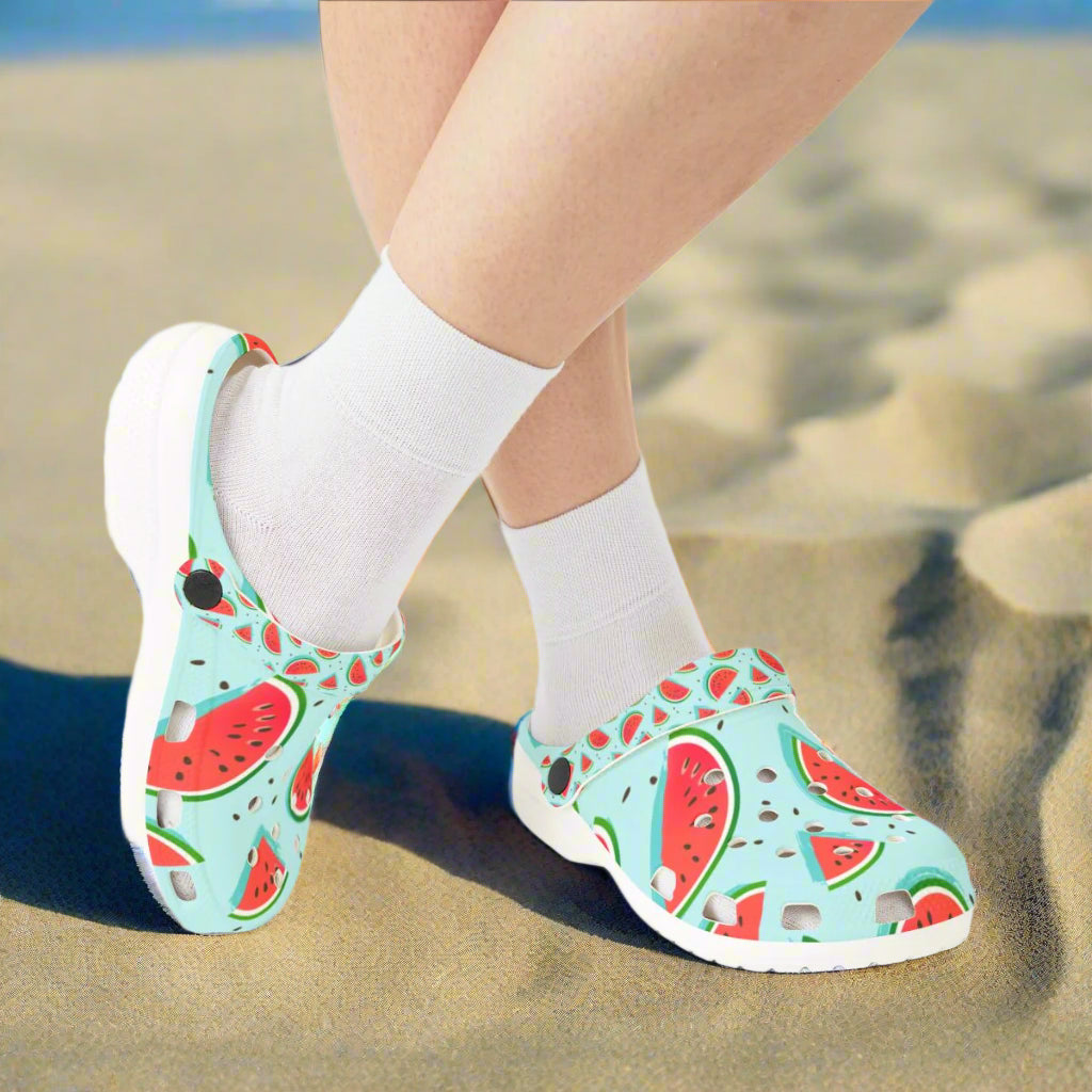 Children's shoes with watermelon pattern worn with white socks on a white background