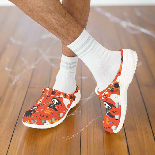 Orange slip-on shoes with Halloween-themed design worn with white socks on a white background