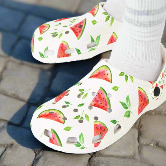 White clogs with watermelon pattern worn by a person with white socks.