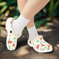 White clogs with watermelon pattern worn with white socks on a white background