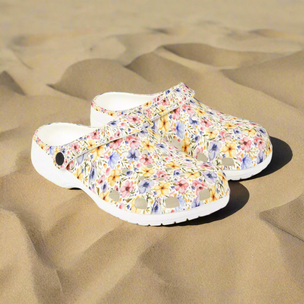 Floral patterned clogs on a white background