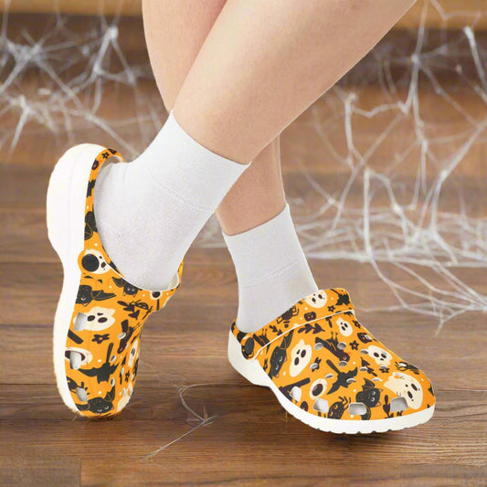Orange shoes with Halloween-themed design worn with white socks on a white background