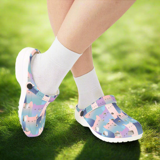 Colorful clogs with cat pattern worn with white socks on a white background