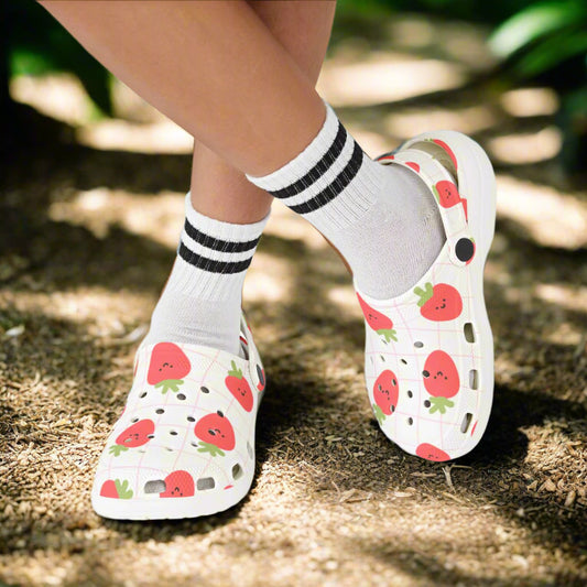 White sandals with strawberry pattern worn with white socks on a white background
