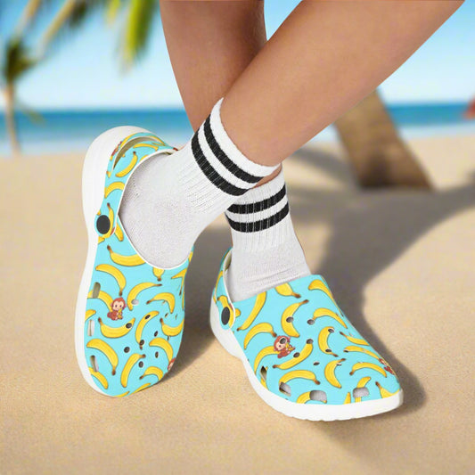 Blue sandals with banana pattern worn by a person on a white background