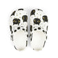 Pair of white slippers with black cat pattern on a white background