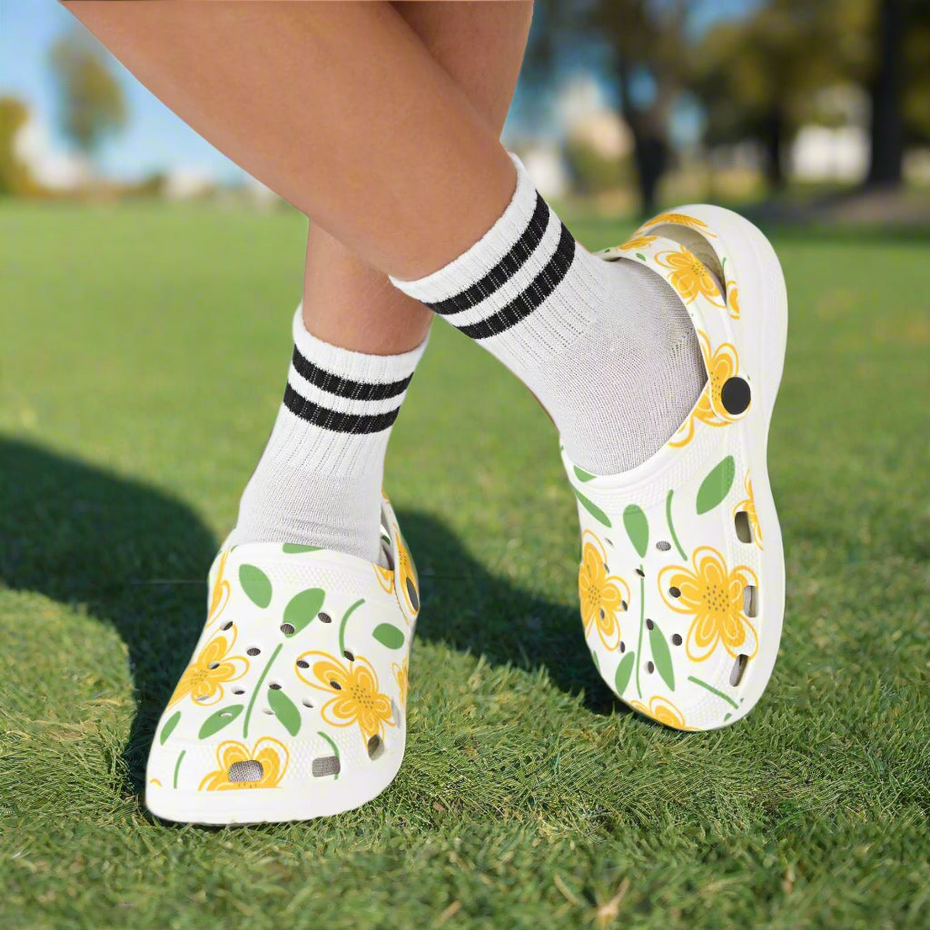 Floral-patterned shoes worn with white socks on a white background
