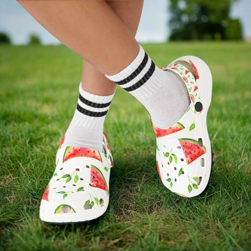 White sandals with watermelon pattern worn with white socks on a white background