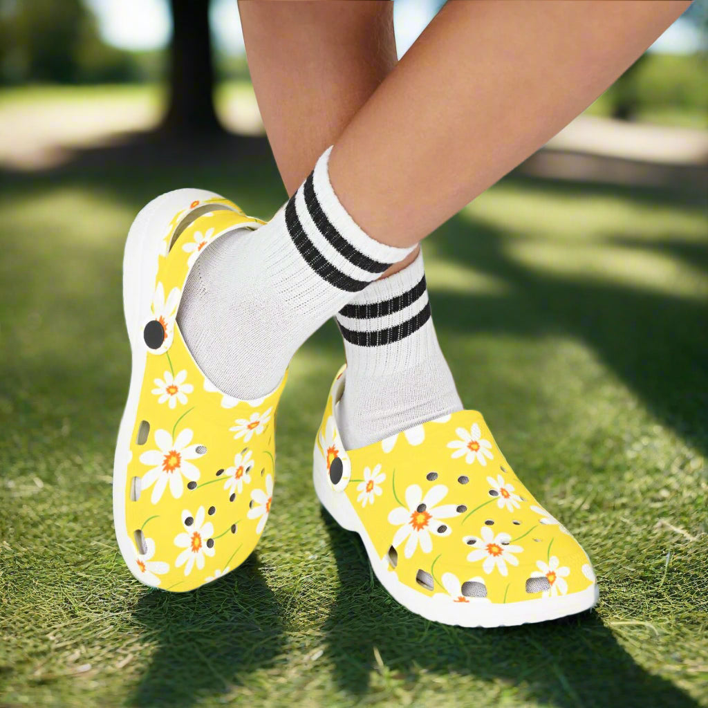 Yellow floral shoes worn with white socks on a white background